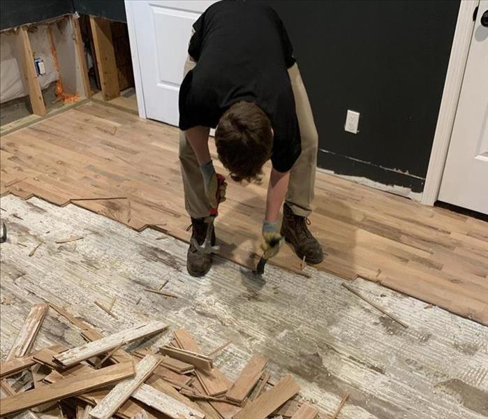 SERVPRO worker removing hardwood floor